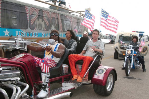President Camacho riding a patriotic trike in a motorcade